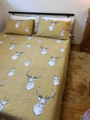 a bed with a deer comforter and pillows at Cambra AGB in Campestrin