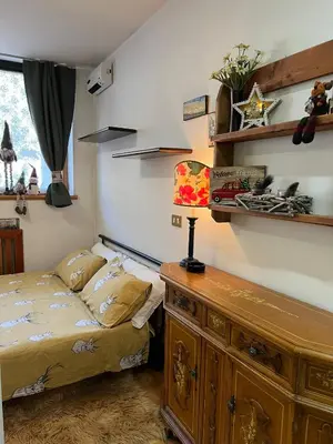 a bedroom with a bed and a wooden dresser at Cambra AGB in Campestrin