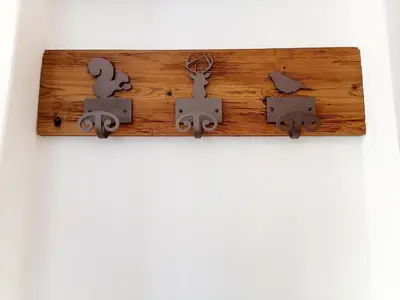 a wooden clipboard with someusted objects on a wall at Villa Re Laurino Suite Tra le nuvole in Moena