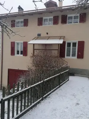 a house with a fence in the snow at Casa Montana & Zampette in Fondo