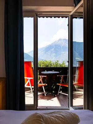 a room with a view of a mountain through a window at B&B Chalet Andy in Schenna