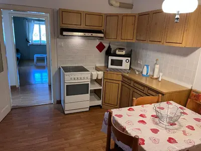 a kitchen with a table and a stove top oven at Ciasa Luciana in Moena