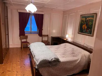 a bedroom with a bed and a window at Ciasa Luciana in Moena