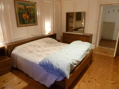 a bedroom with a bed and a mirror at Ciasa Luciana in Moena