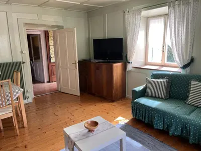 a living room with a couch and a tv at Ciasa Luciana in Moena