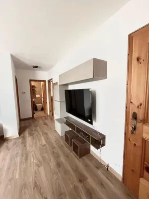 a kitchen with a washing machine and a washer at Appartamento Buca Neve - Tesero in Tesero