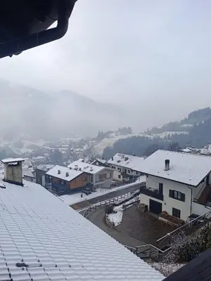a view of a town with snow covered roofs at Appartamento Buca Neve - Tesero in Tesero