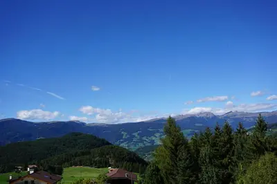 a view of a valley with mountains and trees at Haus Pötzes in Castelrotto