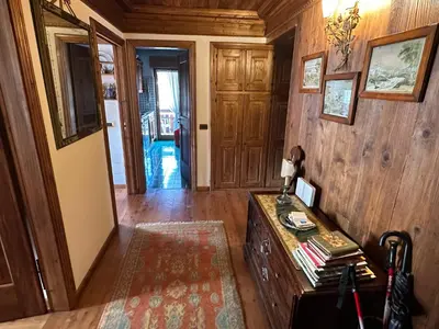 a hallway of a home with a wooden wall at Appartamento 3 camere pieno centro di Cortina in Cortina dʼAmpezzo