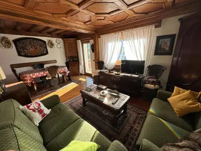 a living room with a couch and a table at Appartamento 3 camere pieno centro di Cortina in Cortina dʼAmpezzo