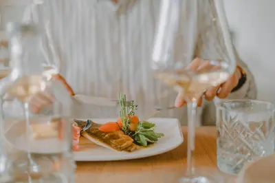 a person sitting at a table with a plate of food at Niedermair Nature Retreat in Parcines