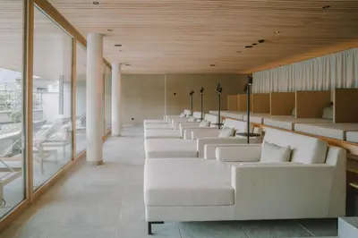 a row of white couches in a waiting room at Niedermair Nature Retreat in Parcines