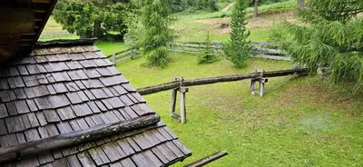 an aerial view of a farm with a wooden fence at Molin in Vigo di Fassa