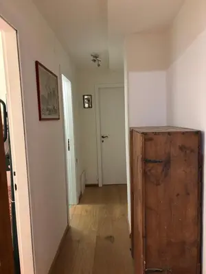 a room with a hallway with a door and a wooden cabinet at Ca' Scalinatella in Cortina dʼAmpezzo