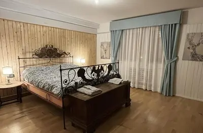 a bedroom with a bed and a table with phones on it at Ca' Scalinatella in Cortina dʼAmpezzo