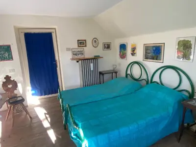 a bedroom with two beds and a blue sheets at Ca' Il Guscio in Cortina dʼAmpezzo