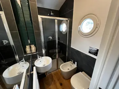 a bathroom with two sinks and two toilets at Ca' Il Guscio in Cortina dʼAmpezzo