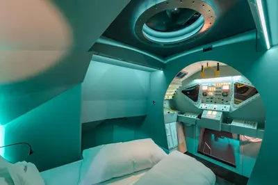 a small room with a bed and a round window at Apollo11 in Collepietra