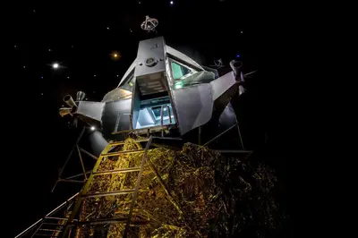 a space shuttle on top of a tower at night at Apollo11 in Collepietra