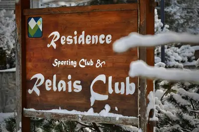 a sign for a restaurant in the snow at Mazzantini appartamento vacanza San Martino di Castrozza in San Martino di Castrozza