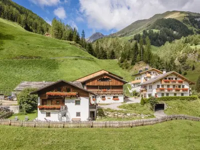 a group of buildings on a green hillside at Apartment Zirbe by Interhome in Selva dei Molini
