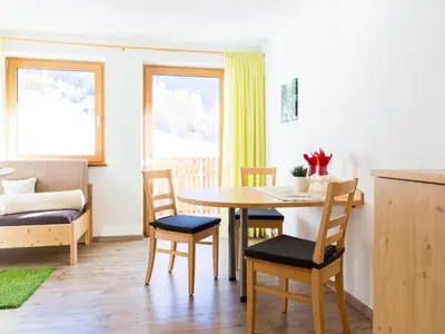 a kitchen and dining room with a table and chairs at Apartment Zirbe by Interhome in Selva dei Molini