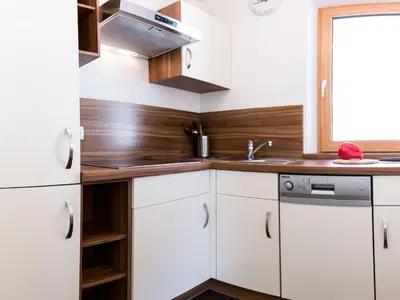 a kitchen with white cabinets and a sink at Apartment Zirbe by Interhome in Selva dei Molini