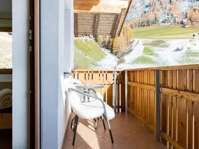 a balcony with a table and chairs and a large window at Apartment Zirbe by Interhome in Selva dei Molini