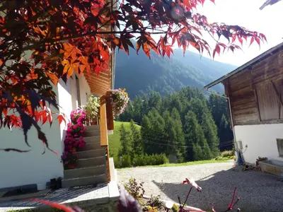 a stairway leading to a house with mountains in the background at Apartment Zirbe by Interhome in Selva dei Molini