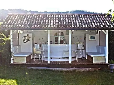 a house with chairs and a bar on a deck at Holiday Home Mirror House Nord by Interhome in Bolzano