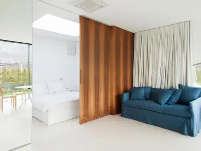 a living room with a couch and a bed at Holiday Home Mirror House Nord by Interhome in Bolzano