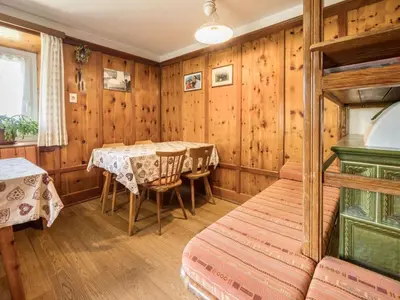 a room with a table and a bed in it at Apartment Haus Adler by Interhome in Maranza