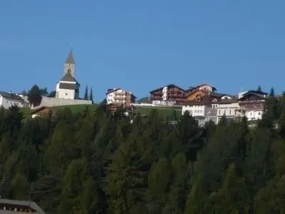 a group of houses on a hill with a church at Apartment Haus Adler by Interhome in Maranza