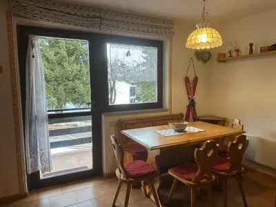 a dining room with a table and chairs and a window at Il Gufo Bianco in Carano
