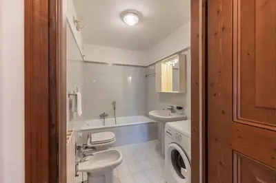 a bathroom with a sink and a washing machine at Casa Tre Corone, sulla strada per Cortina in Borca di Cadore