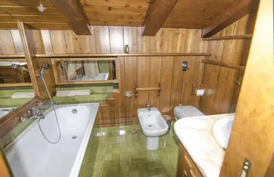 a bathroom with a tub and a toilet and a sink at Appartamento panoramico vicino centro in Cortina dʼAmpezzo