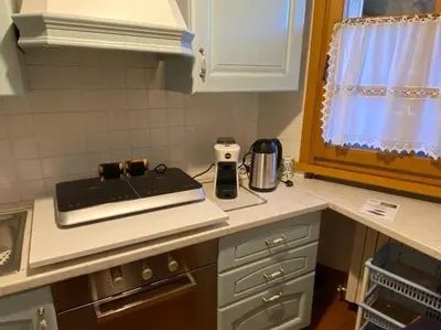 a kitchen with a counter top with a stove at Un angolo di relax sulle Dolomiti ampezzane in Cortina dʼAmpezzo