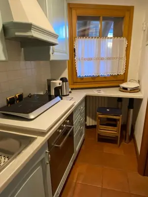 a kitchen with a sink and a stove top oven at Un angolo di relax sulle Dolomiti ampezzane in Cortina dʼAmpezzo