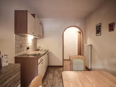 a kitchen with a table and a dining room at Fermeda in Villnoss