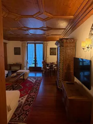 a living room with a flat screen tv and a couch at Ca dell'Alba in Cortina dʼAmpezzo