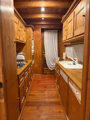 a kitchen with wooden cabinets and a sink at Ca dell'Alba in Cortina dʼAmpezzo