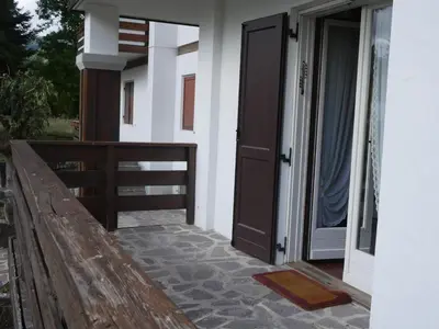 an open door of a house with a porch at Ca dell'Alba in Cortina dʼAmpezzo