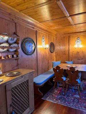 a dining room with a table and two chairs at Ca dell'Alba in Cortina dʼAmpezzo
