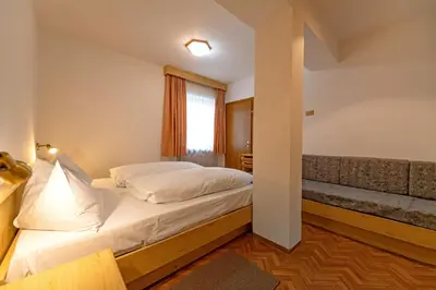 a bedroom with a bed and a window at Apartments Jasmin in Selva di Val Gardena