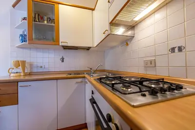 a kitchen with a stove and a sink at Apartments Jasmin in Selva di Val Gardena