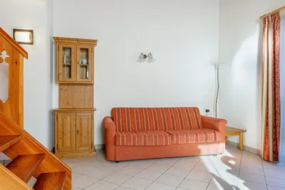 a staircase in a house with a green bench at Appartamenti Villa Elisa - Falcade in Falcade