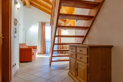 a bathroom with a wooden dresser and a mirror at Appartamenti Villa Elisa - Falcade in Falcade