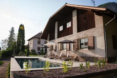 a house with a swimming pool in front of it at Linslhof in Terlano