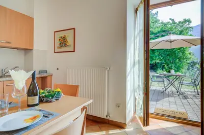 a kitchen with a table with a bottle of wine at Linslhof in Terlano