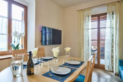 a dining room with a table with a bottle of wine at Linslhof in Terlano